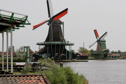 A group of windmills are sitting on a dock