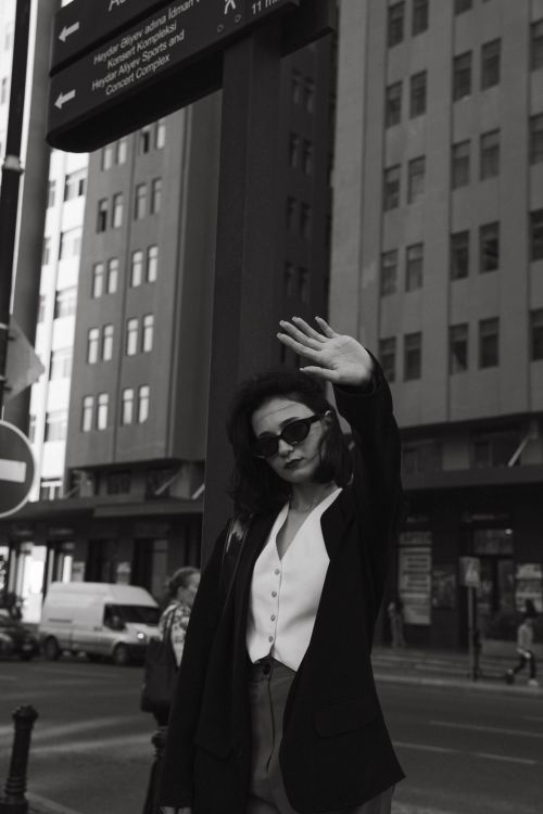 Free Black and white portrait of a woman posing in Bakü's cityscape. Stock Photo