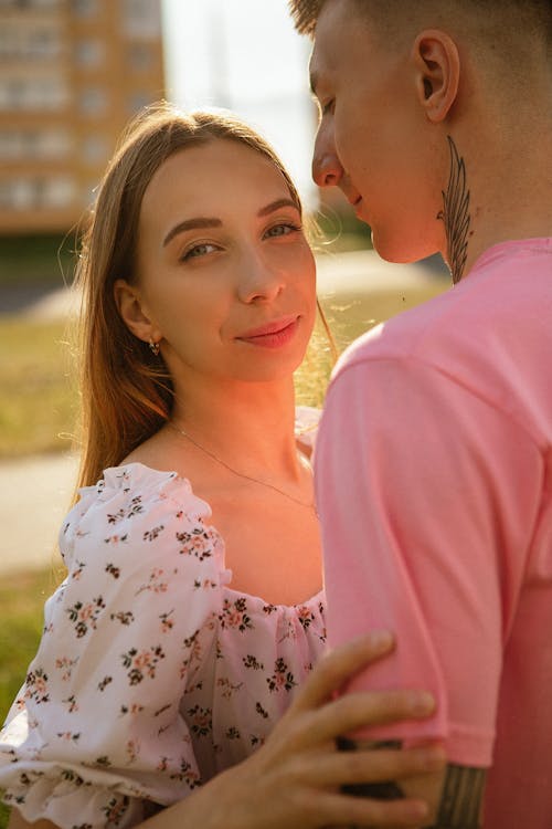 A young man and woman are standing in front of each other