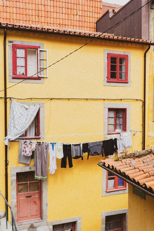 Free Charming yellow building with laundry in urban Porto, Portugal. Stock Photo