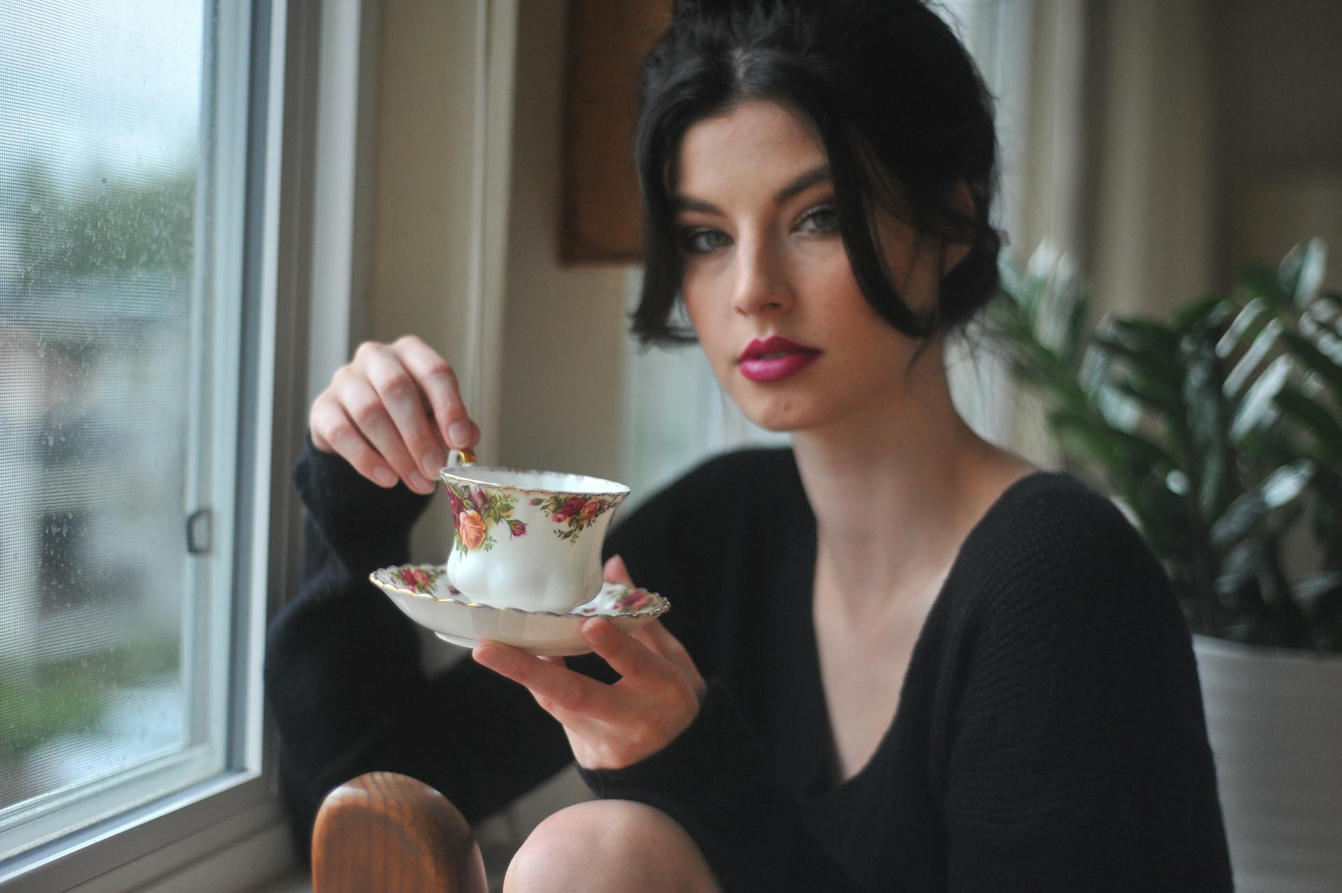 Woman Holding White Saucer And Teacup