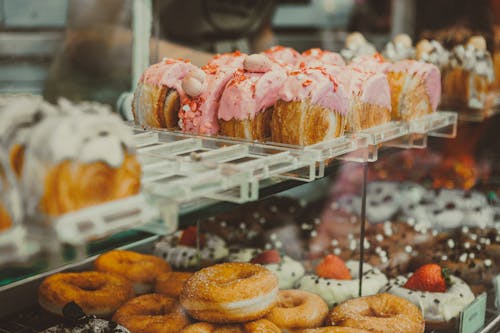 A display case filled with pastries and doughnuts