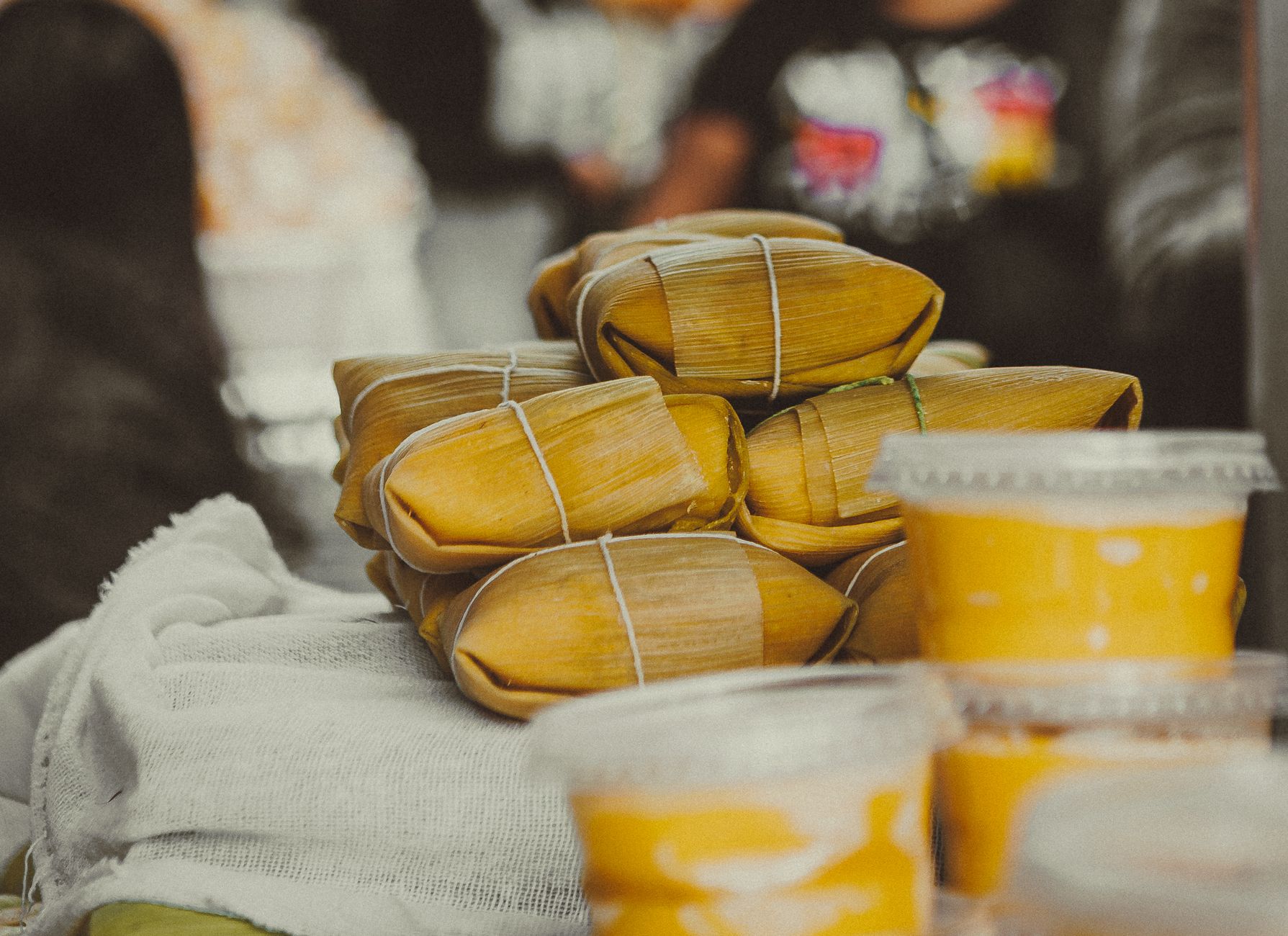 Fresh tamales served on a plate with dipping sauce
