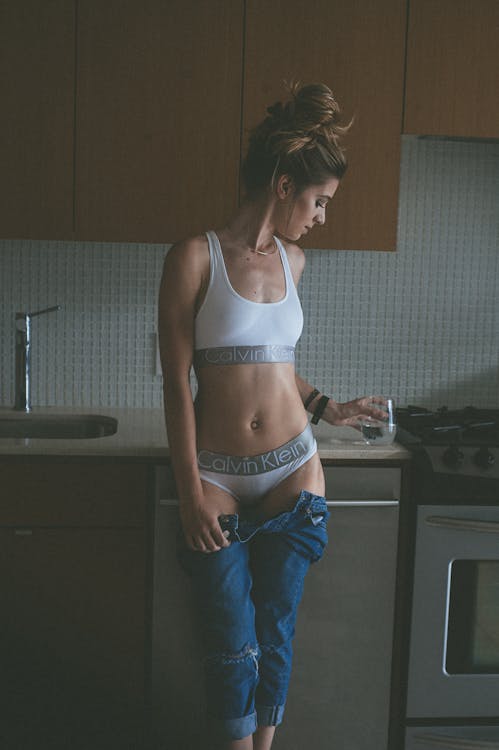 Free Photo Woman Wearing White Calvin Klein Brassiere and Pantie Holding a Water Glass in  Kitchen Stock Photo