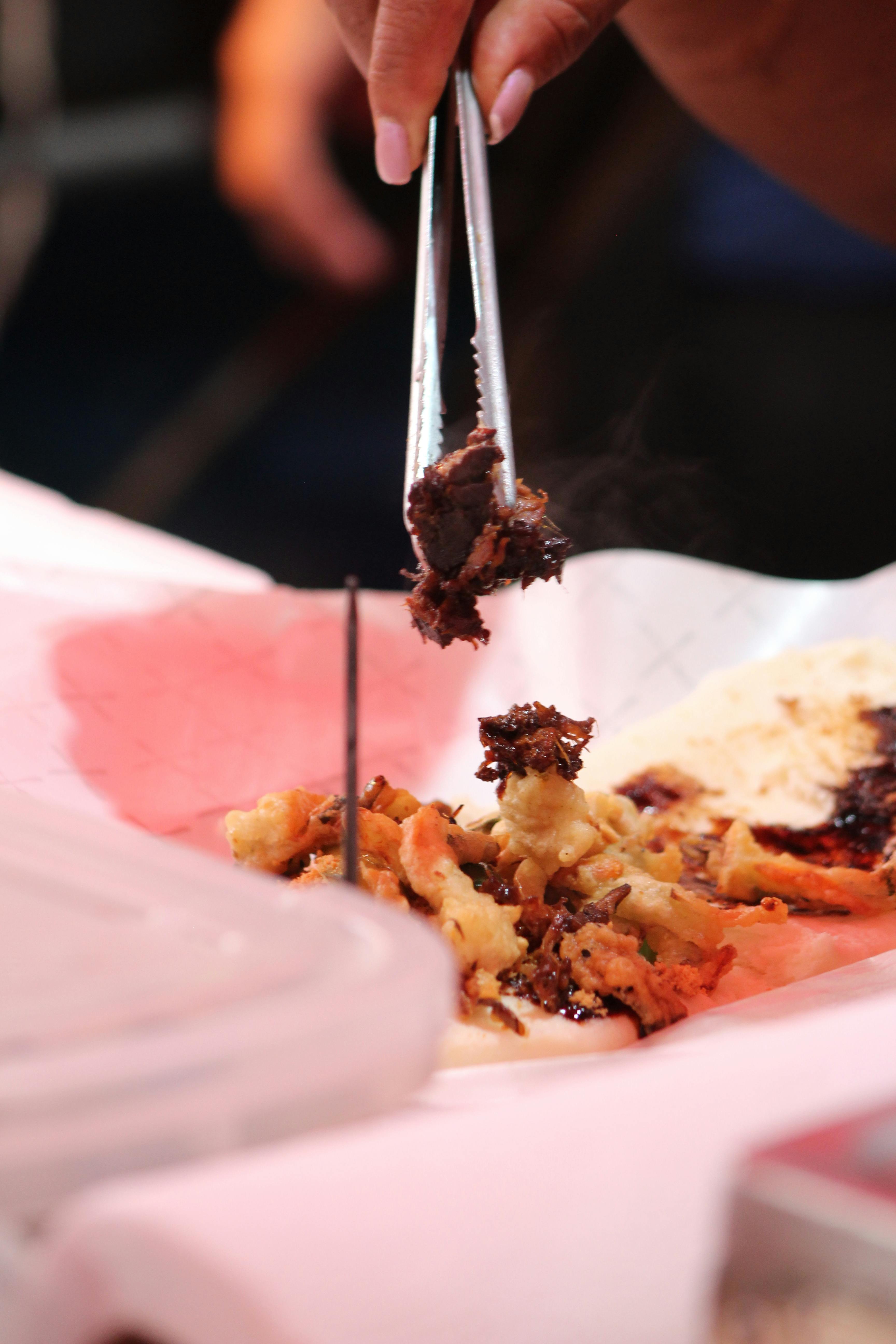 A close-up shot of a chef expertly plating a dish with intricate details