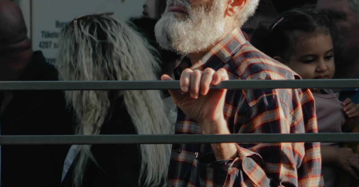 People Standing Behind Railing Elderly Man with Beard Standing in Shirt behind Railing · Free Stock Photo
