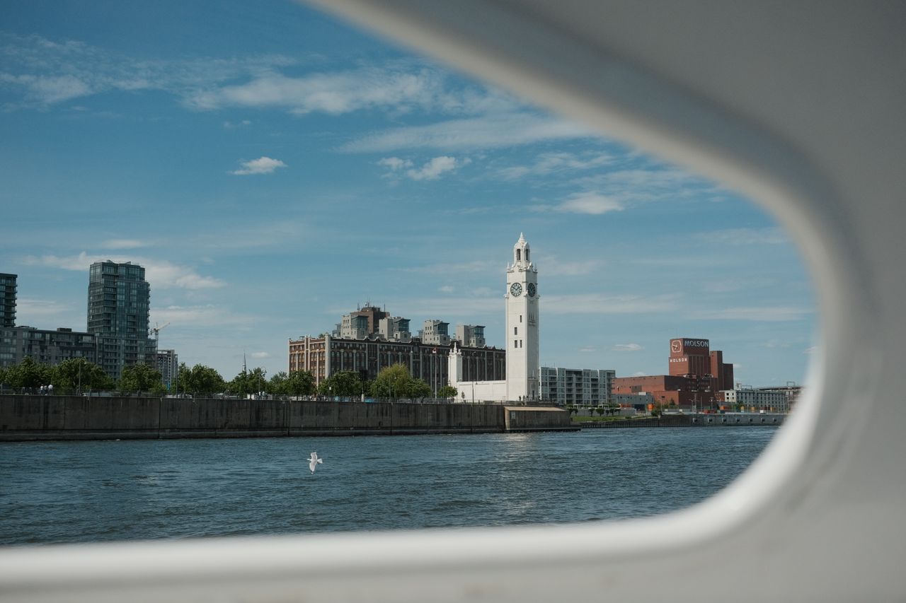 Scenic view of Montreal's iconic Clock Tower from the water on a clear day.