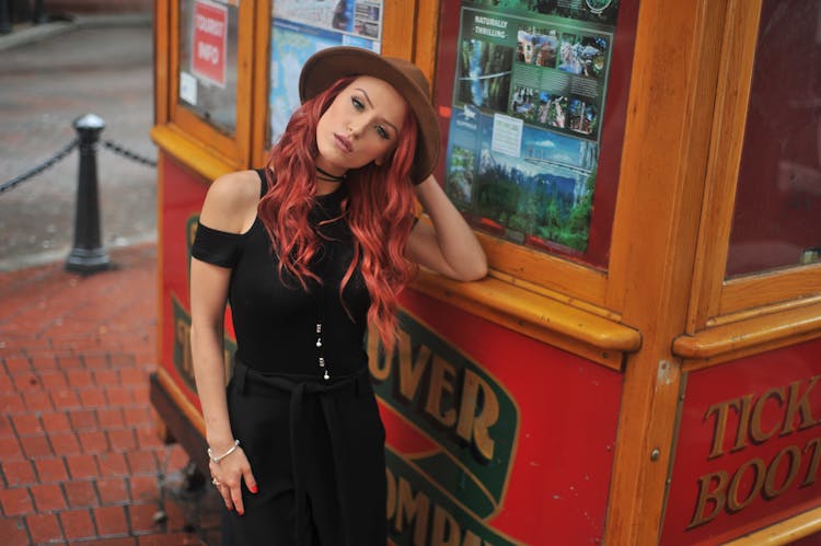 Photo Of Woman Leaning On A Ticket Booth