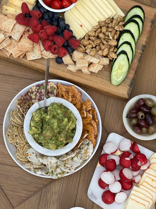 A table with a variety of foods including fruit, nuts and cheese