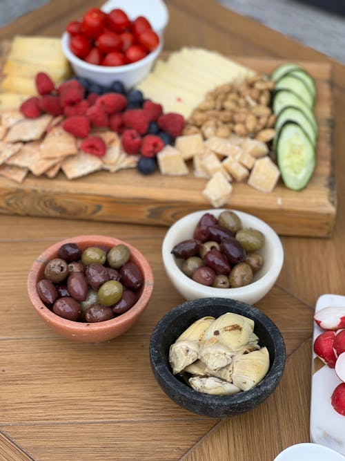 A table with cheese, fruit and crackers
