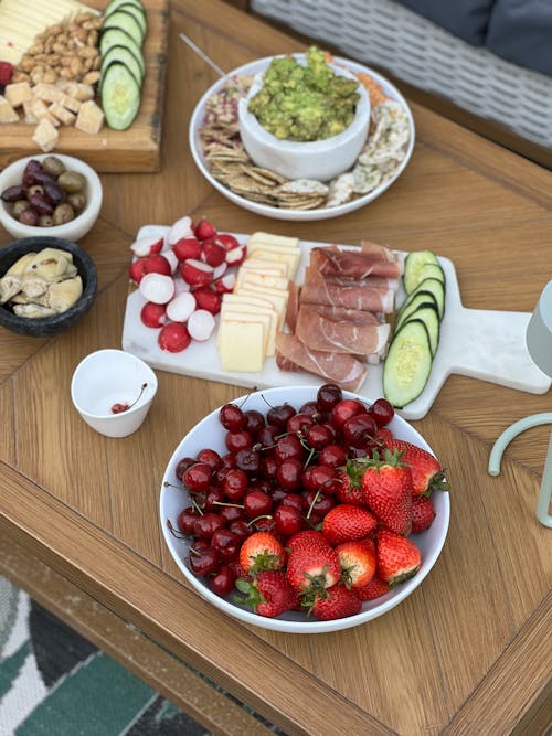 A table with fruit, nuts, and cheese on it