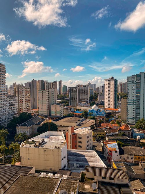 Free A stunning cityscape featuring modern skyscrapers under a bright blue sky, showcasing urban life. Stock Photo