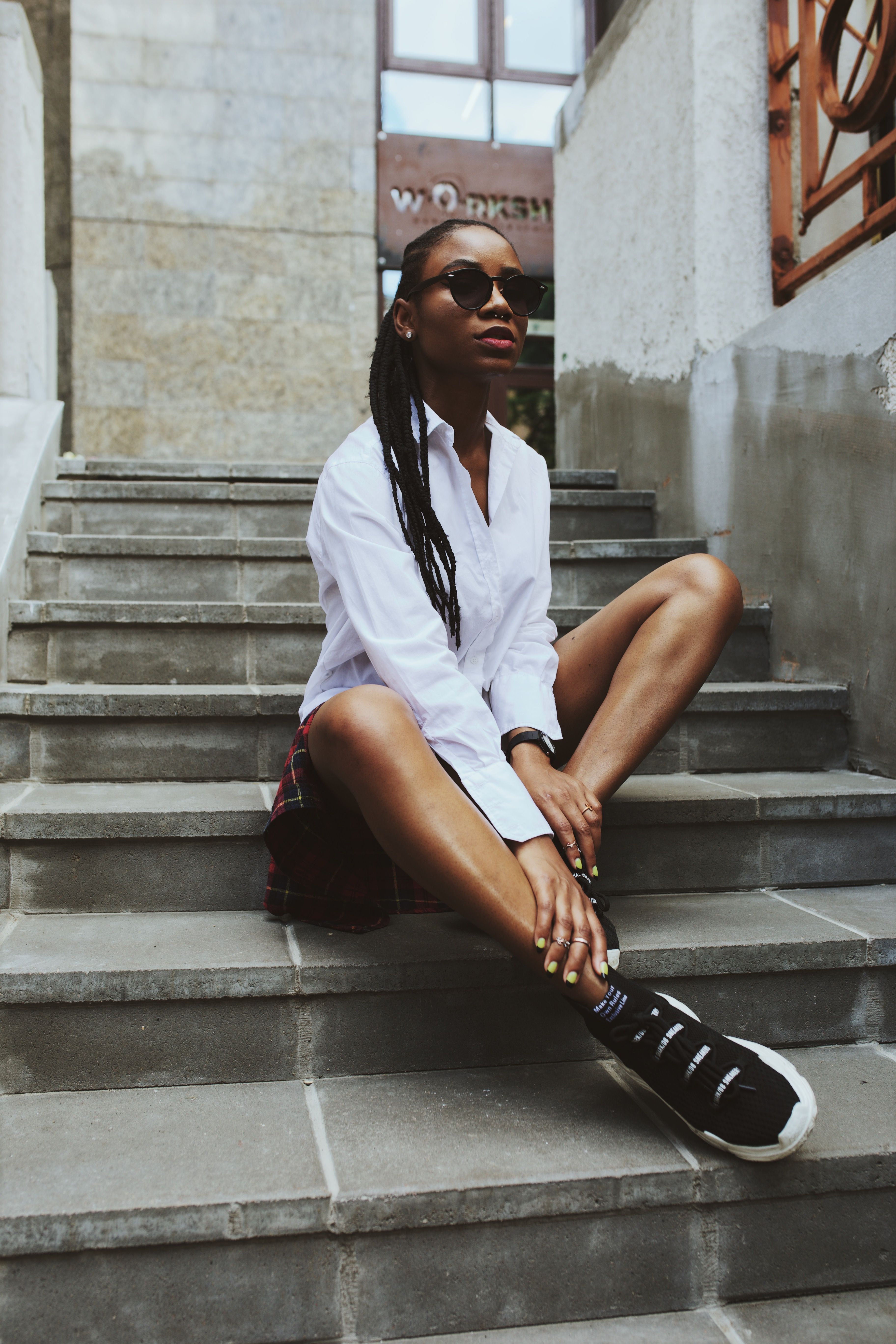 Photo of Woman Sitting on Concrete Stairs Posing · Free Stock Photo