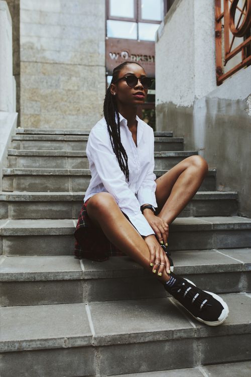 Photo of Woman Sitting on Concrete Stairs Posing · Free Stock Photo