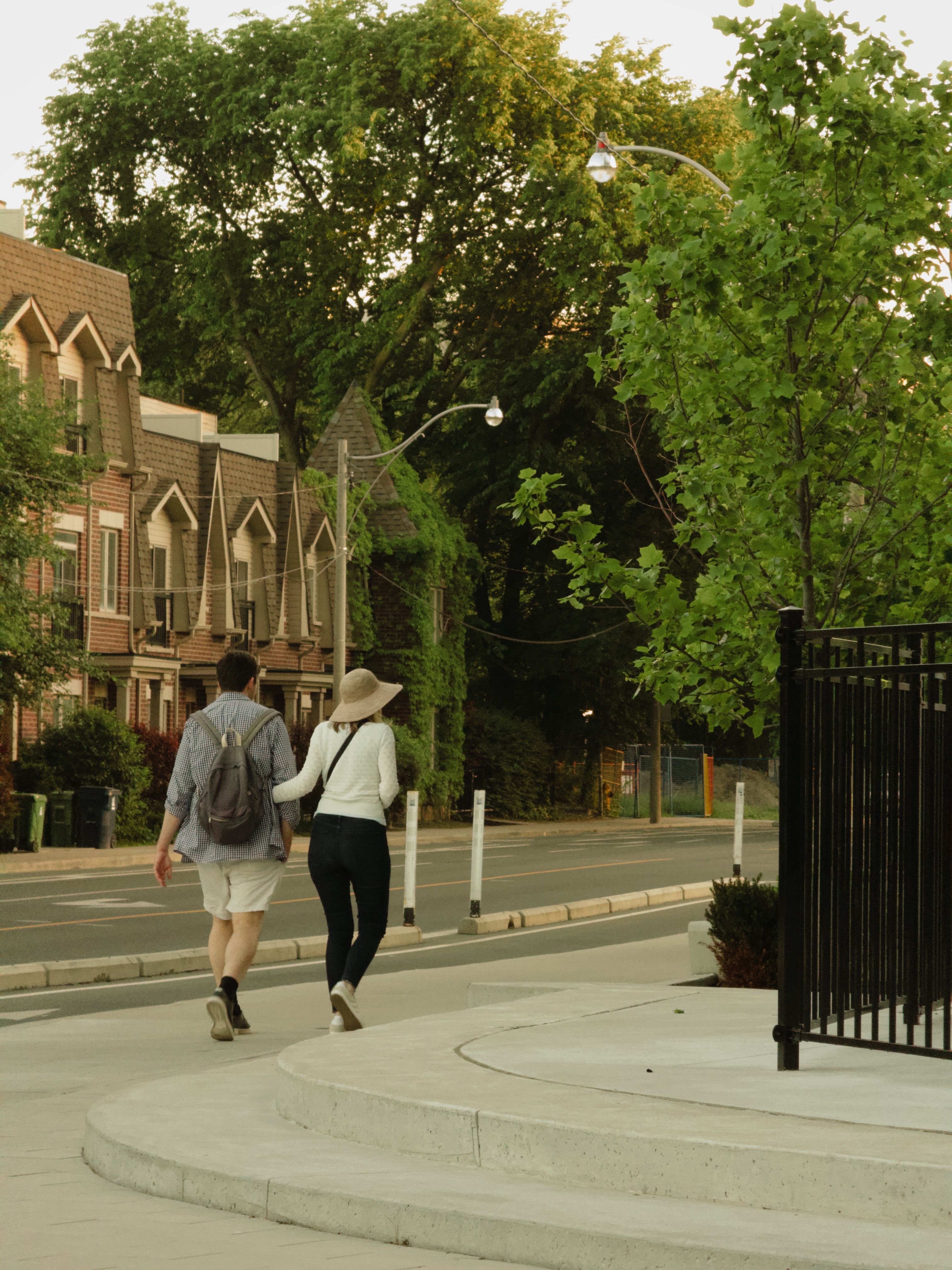 Back View of a Couple Walking on a Sidewalk · Free Stock Photo
