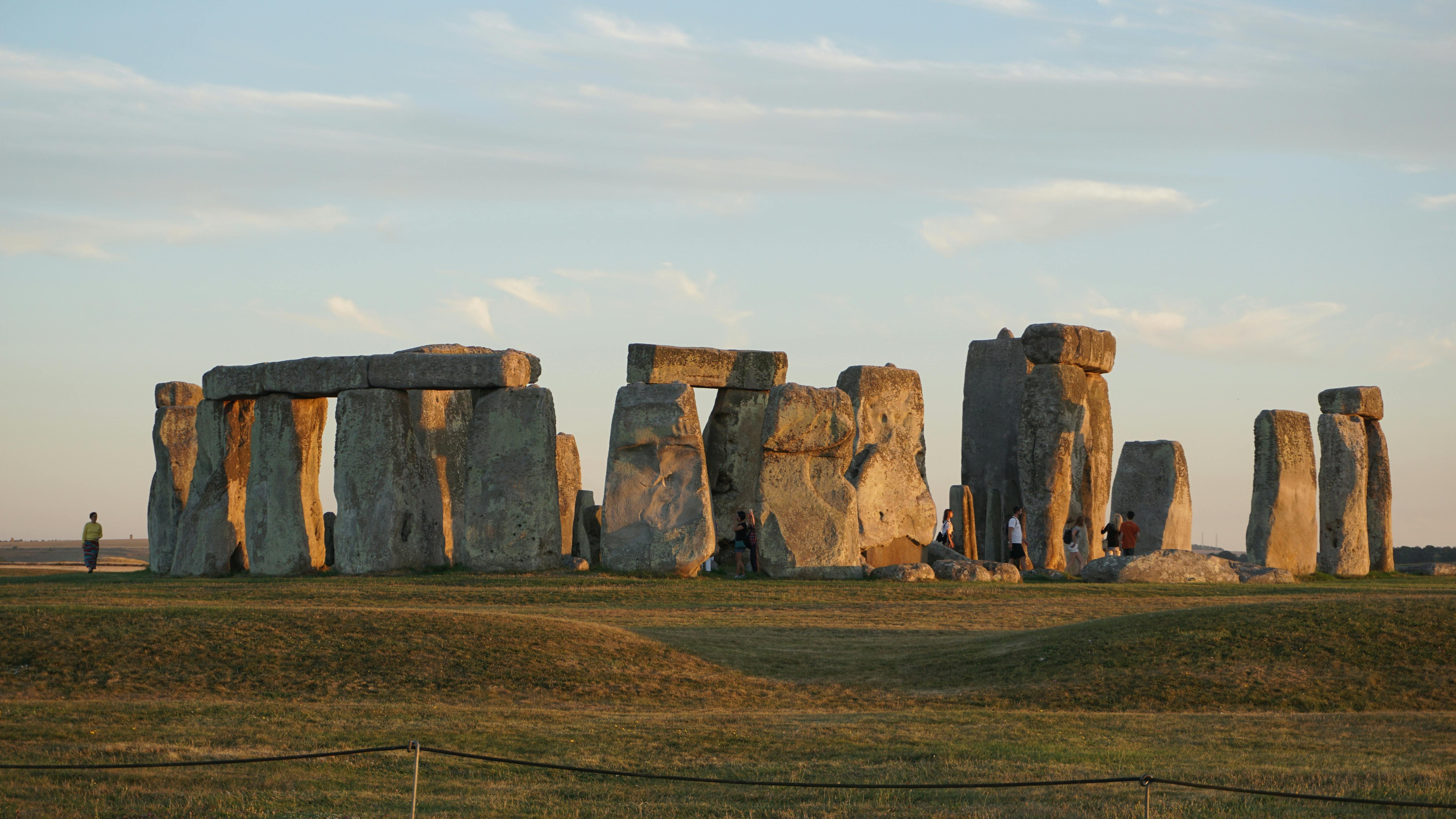 photo of people standing near stonehenge