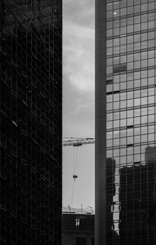 Grayscale Photo of two high rise buildings