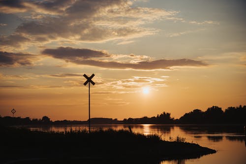 A windmill is silhouetted against the sunset