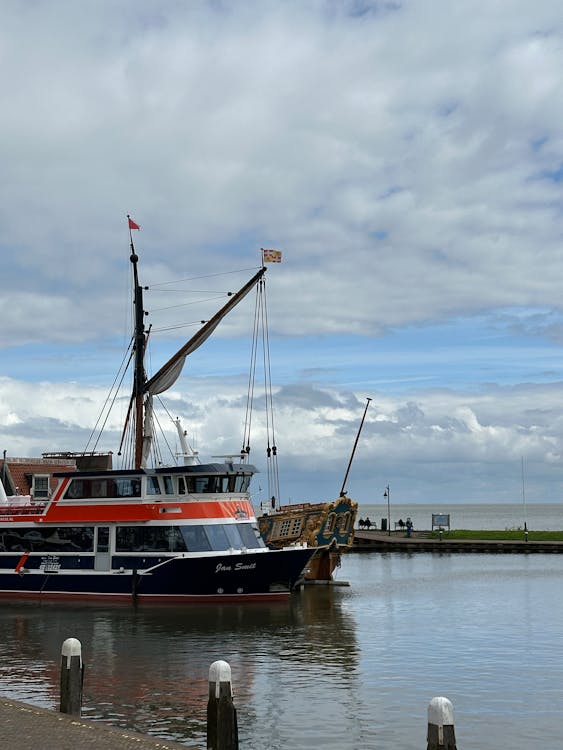 A boat docked at a dock with a crane