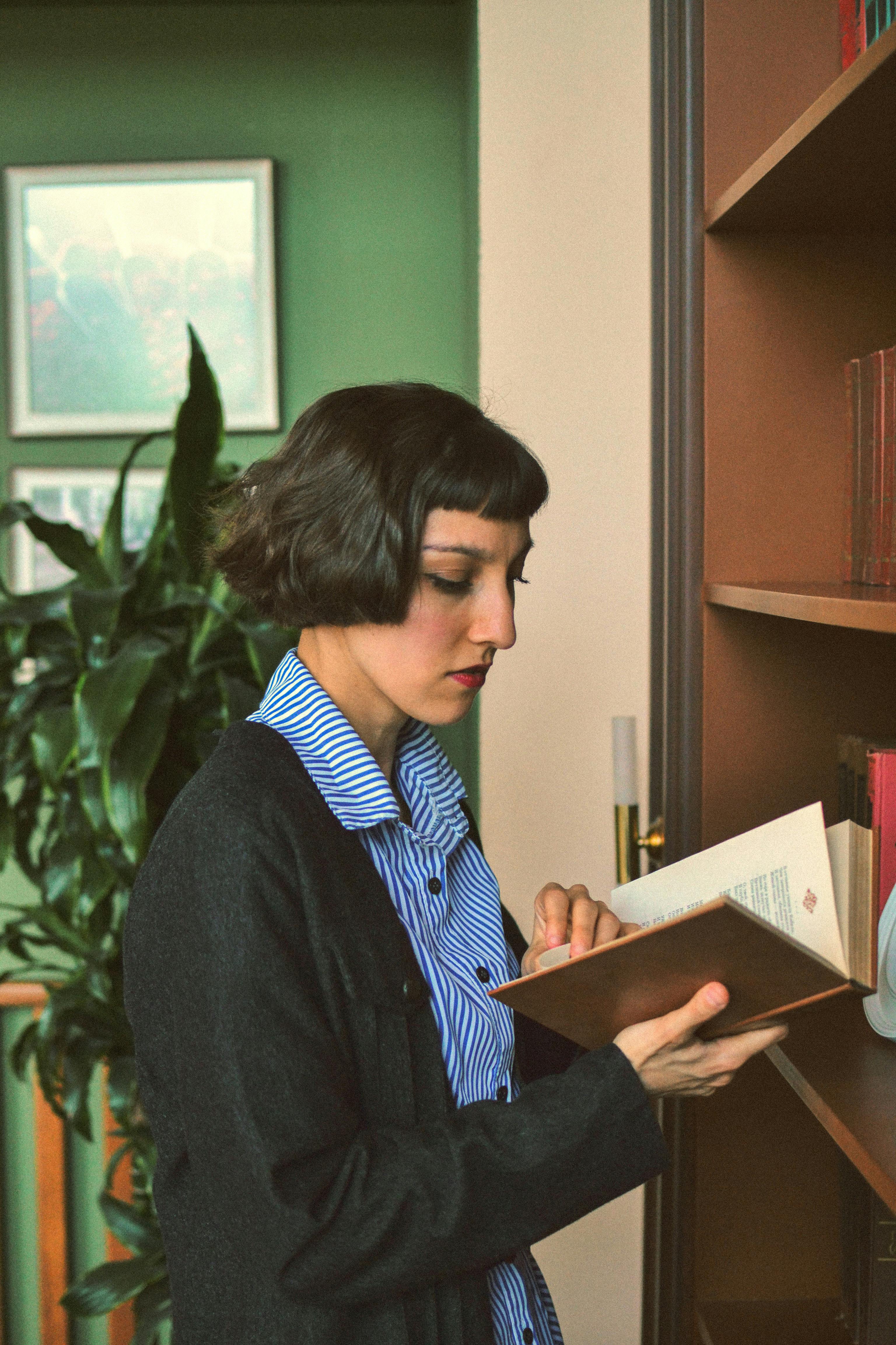 Thoughtful woman reading a book in a library in Azerbaijan