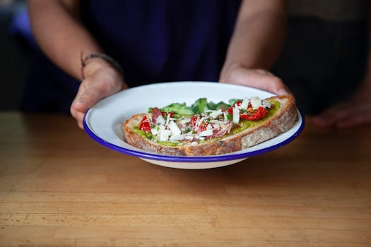 Close-up of avocado toast with tomatoes and cheese, perfect for healthy meals.