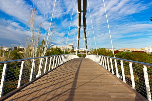 A bridge with a white railing and a blue sky