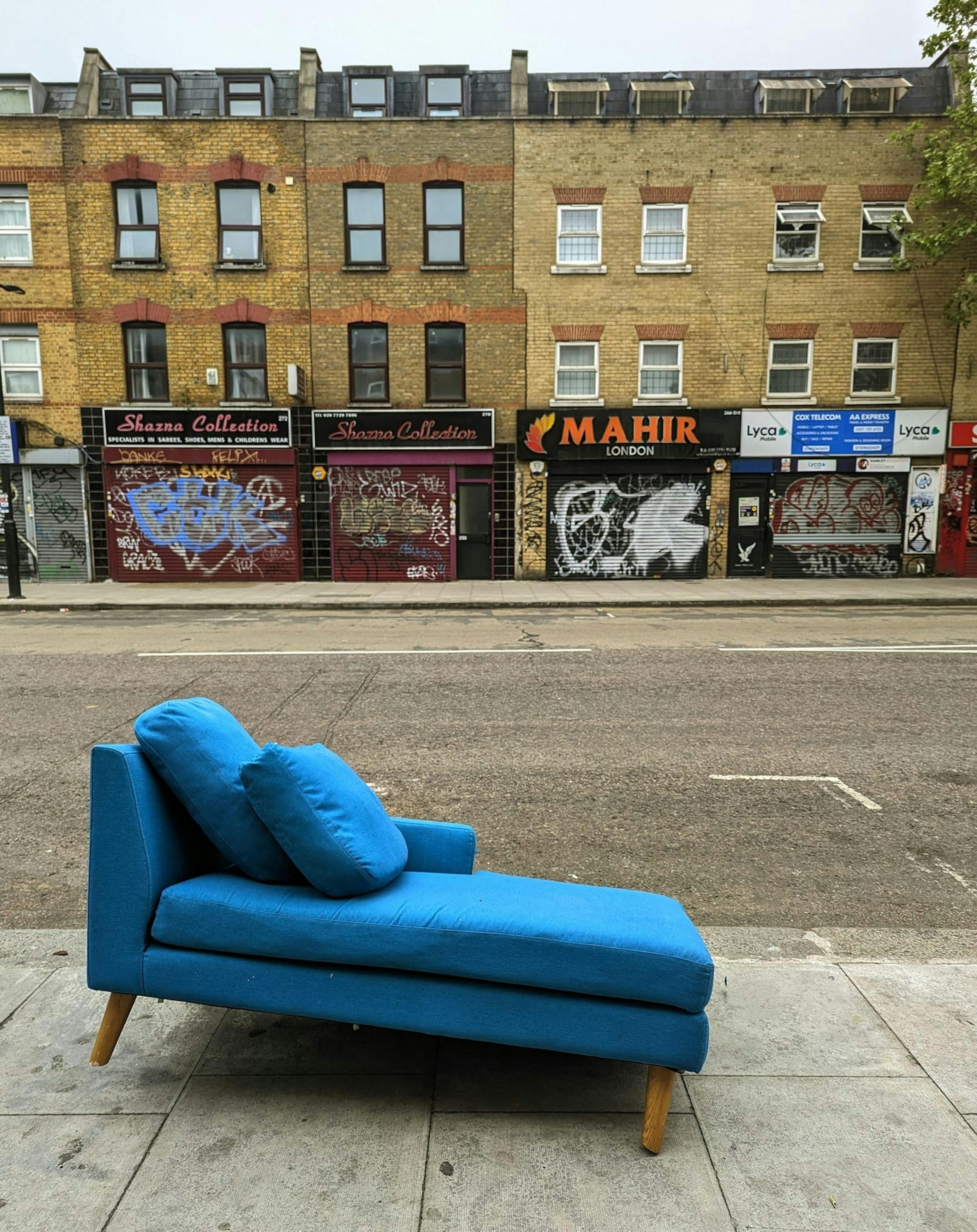 Blue sofa on the curb