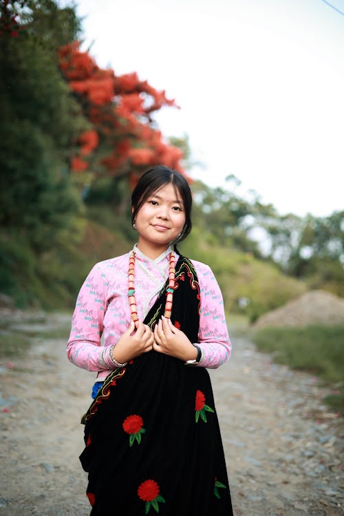 Woman in Traditional Clothing Standing in a Path