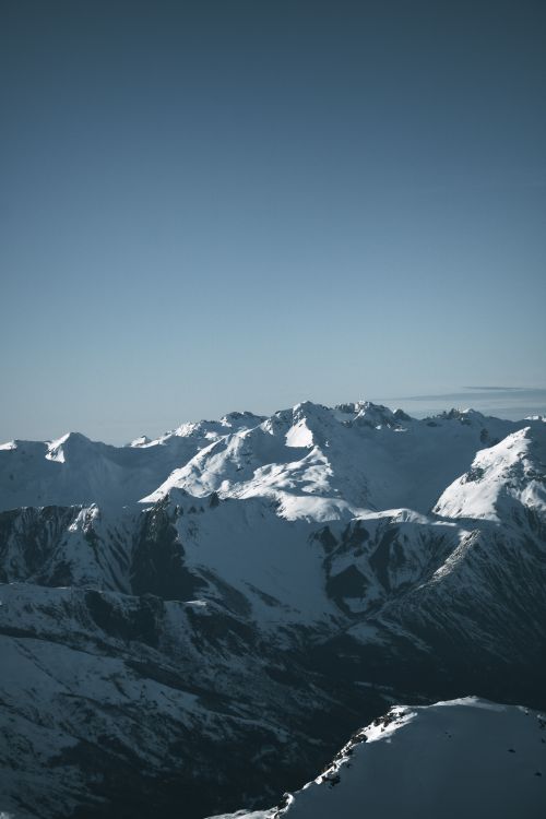 Free Breathtaking view of snow-capped mountains under a clear blue sky, showcasing natural beauty and tranquility. Stock Photo
