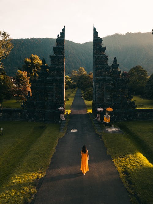 Free Back View of a Woman Walking Towards the Famous Bali Handara Gate Stock Photo