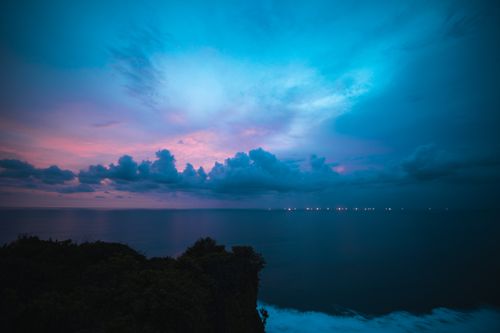 Free Experience the serene twilight sky over Bali's coastline, capturing a stunning blend of colors and peaceful ocean views. Stock Photo