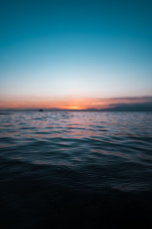 Free Peaceful ocean sunrise with rich colors and gentle waves, capturing serene beauty in Thailand. Stock Photo