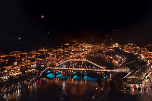 Free Explore the vibrant night scene of Fenghuang Ancient Town, a historic and cultural gem in Hunan, China. Stock Photo