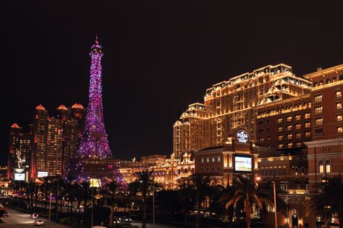 Free Vibrant night view of the Parisian Macao featuring its iconic illuminated Eiffel Tower replica. Stock Photo