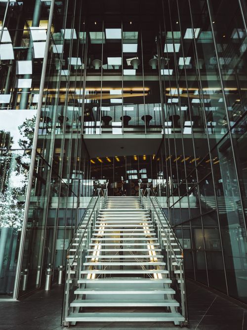 Free Sleek glass staircase inside a modern building in Bonn, showcasing contemporary architectural design. Stock Photo