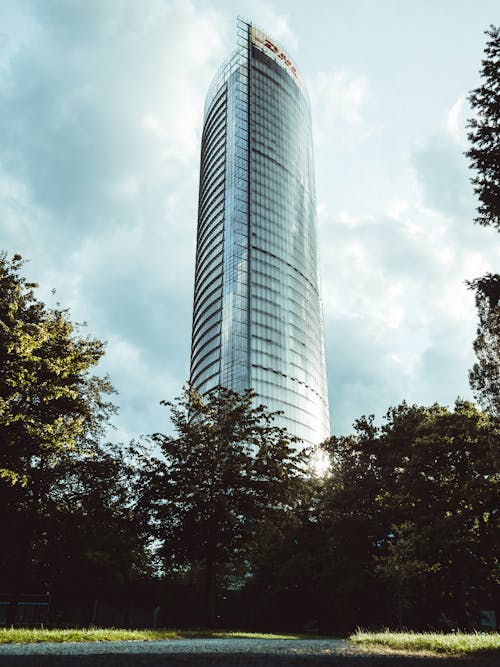 Low Angle Photo of High-Rise Building Under Cloudy Sky