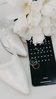 Elegant wedding essentials including shoes, rings, flowers, and a calendar app, perfect for planning the big day.