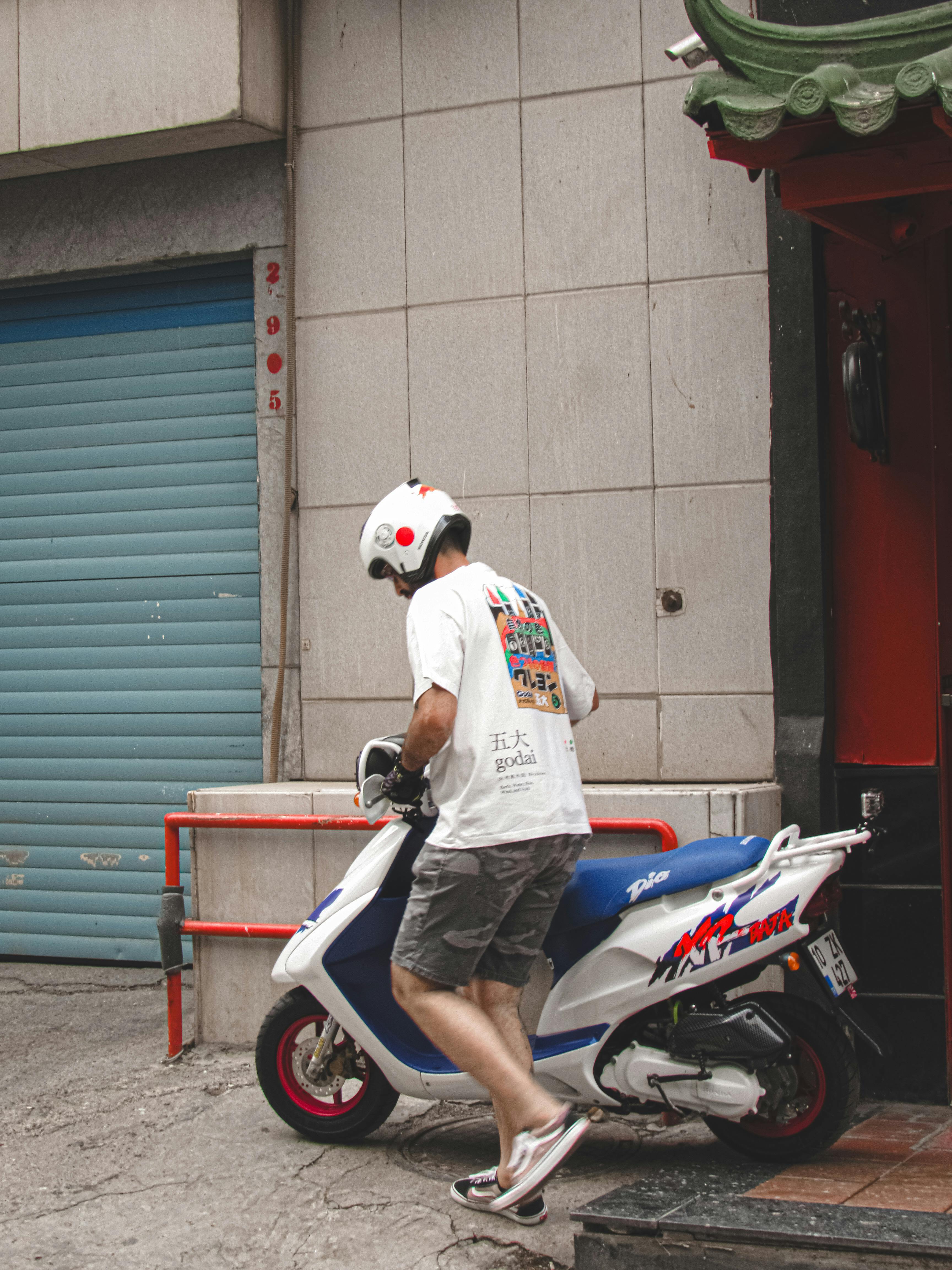 Man in Helmet Getting on Moped · Free Stock Photo