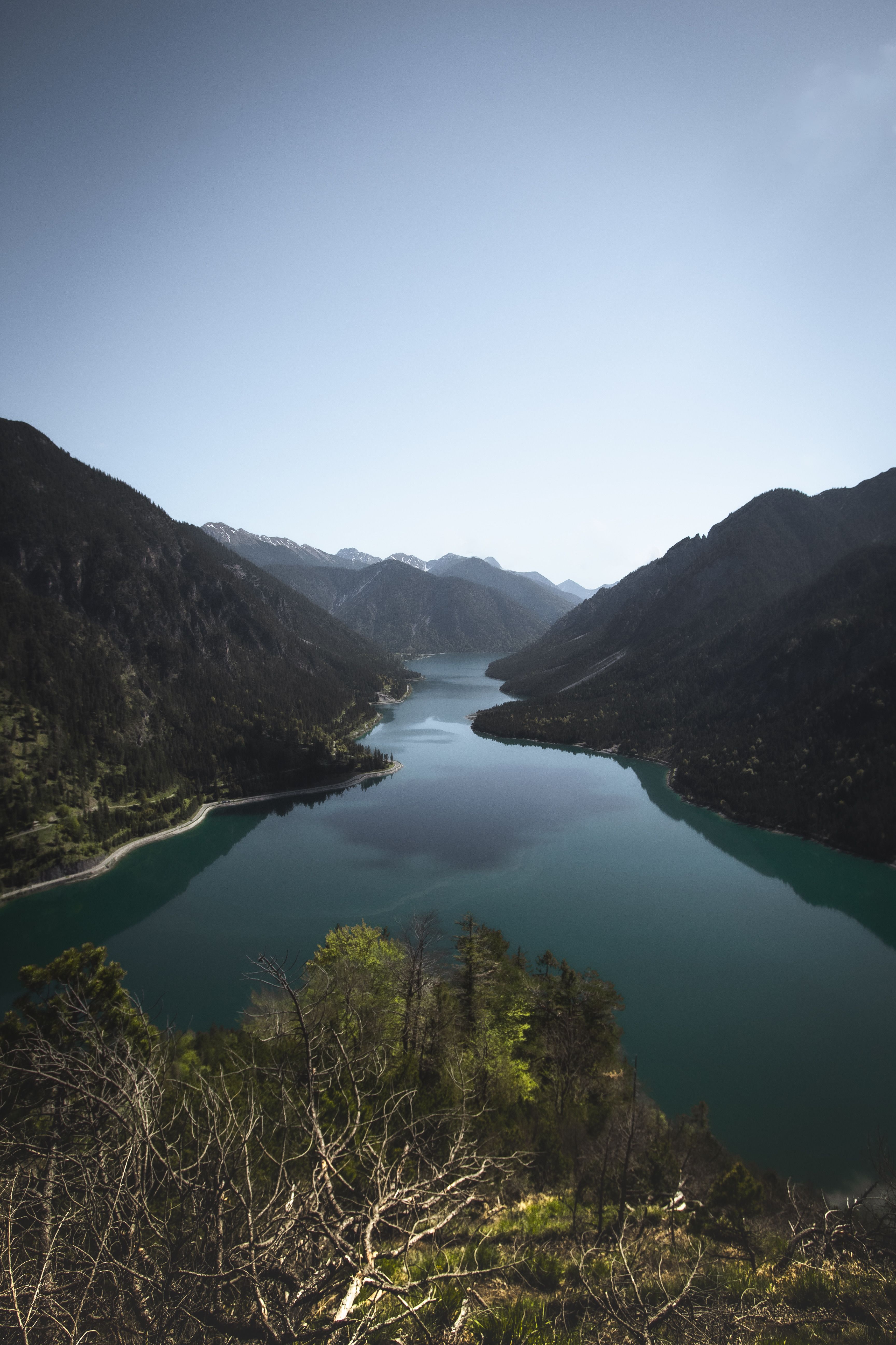 A breathtaking aerial view of Plansee surrounded by mountains in Tirol, Austria