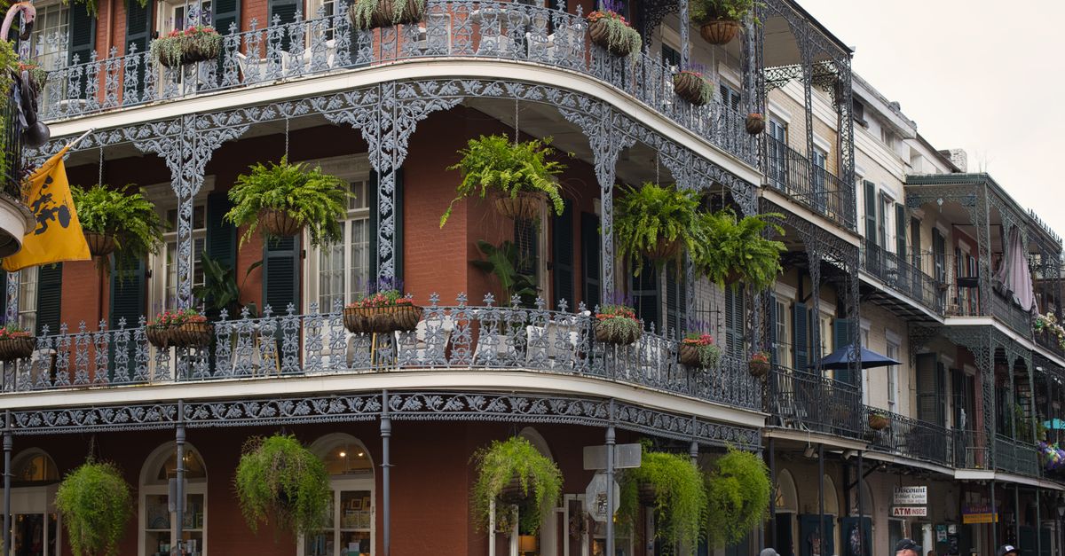 Wrought-iron balconies and greenery on a New Orleans French Quarter street