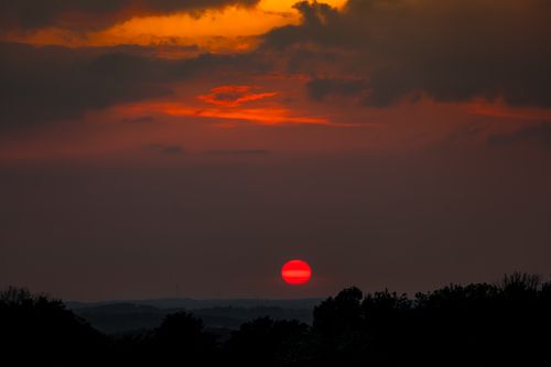 Free Breathtaking red sunset with dramatic clouds, ideal for landscape and nature themes. Stock Photo