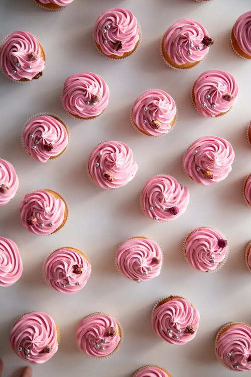 A close up of pink cupcakes with frosting
