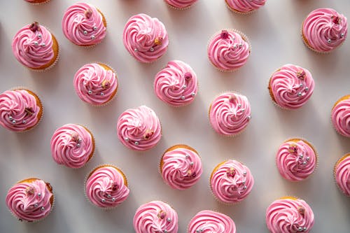 A close up of pink cupcakes on a white background
