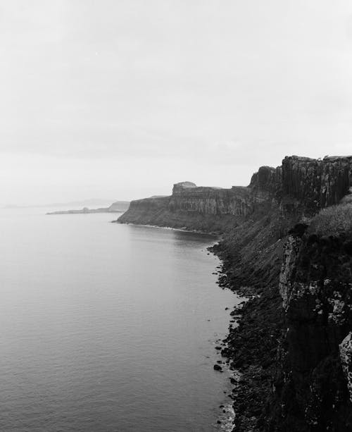 Black and white photograph of the ocean and cliffs