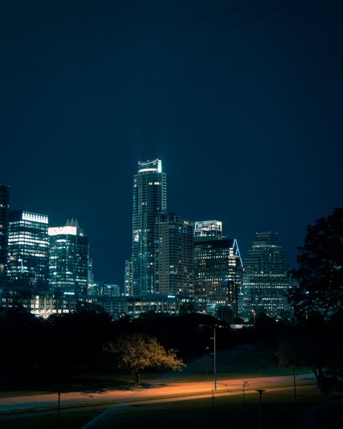 Illuminated towers at night by Alberto Alvarez on Pexels