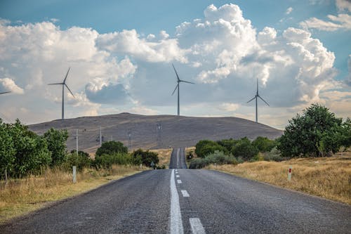 A road with wind turbines in the background
