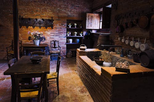 A kitchen with a brick wall and a table