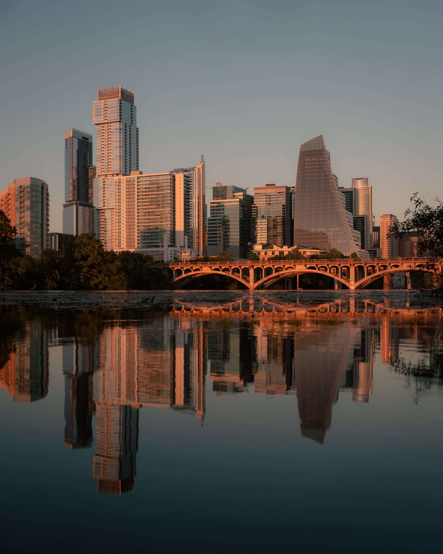 Austin skyline reflected in the river at sunset