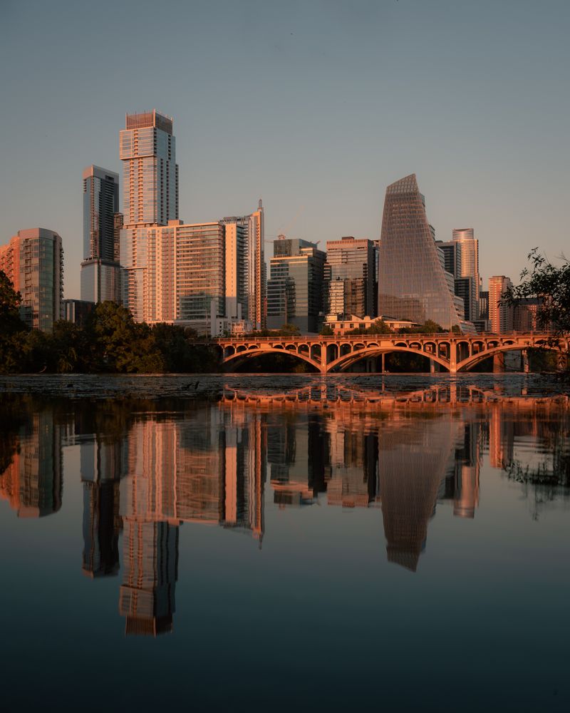 Downtown Austin skyline reflected in the river at sunset