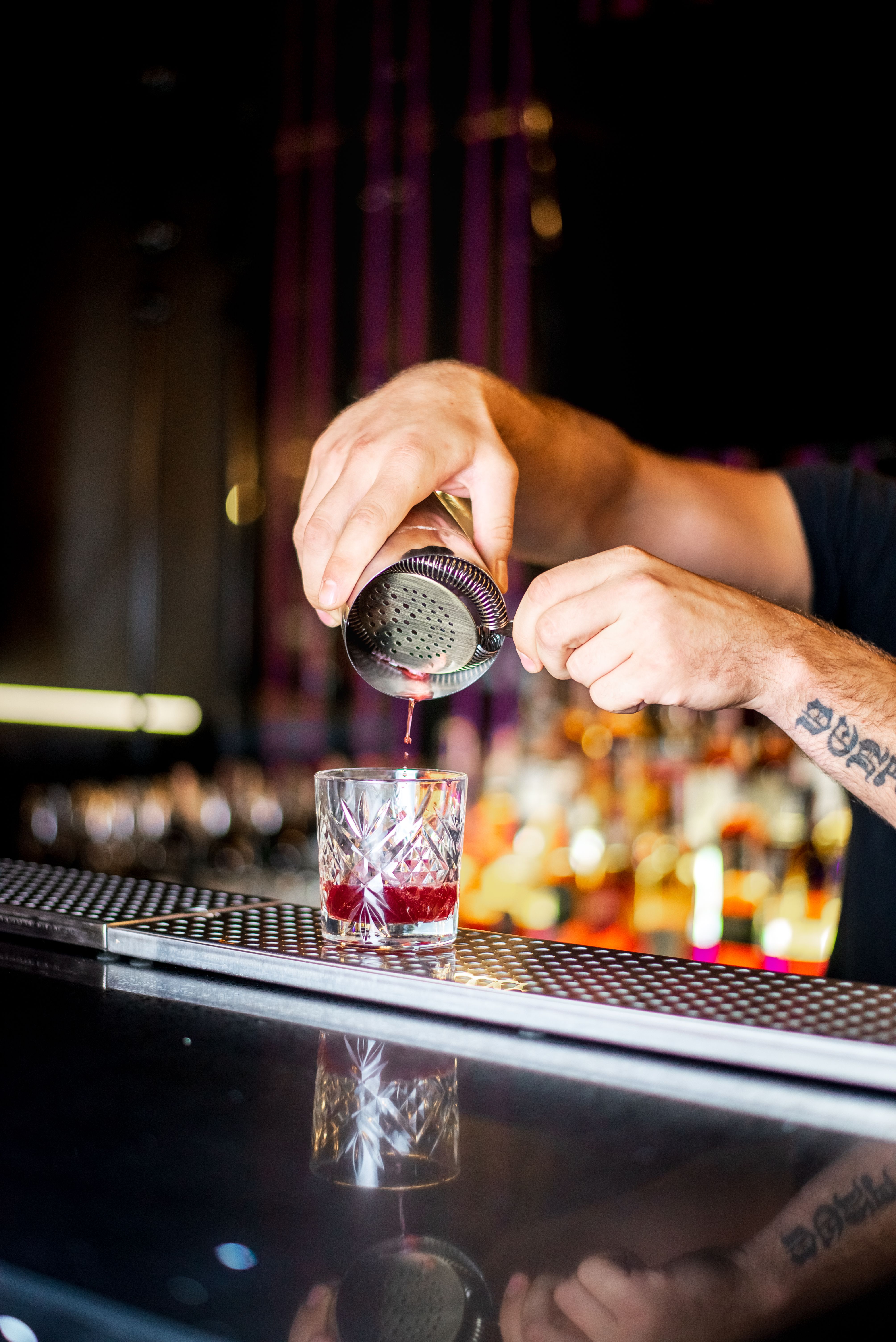 Close-up of a bartender pouring a cocktail at a trendy bar in Kyiv, Ukraine. Perfect for lifestyle and nightlife themes.